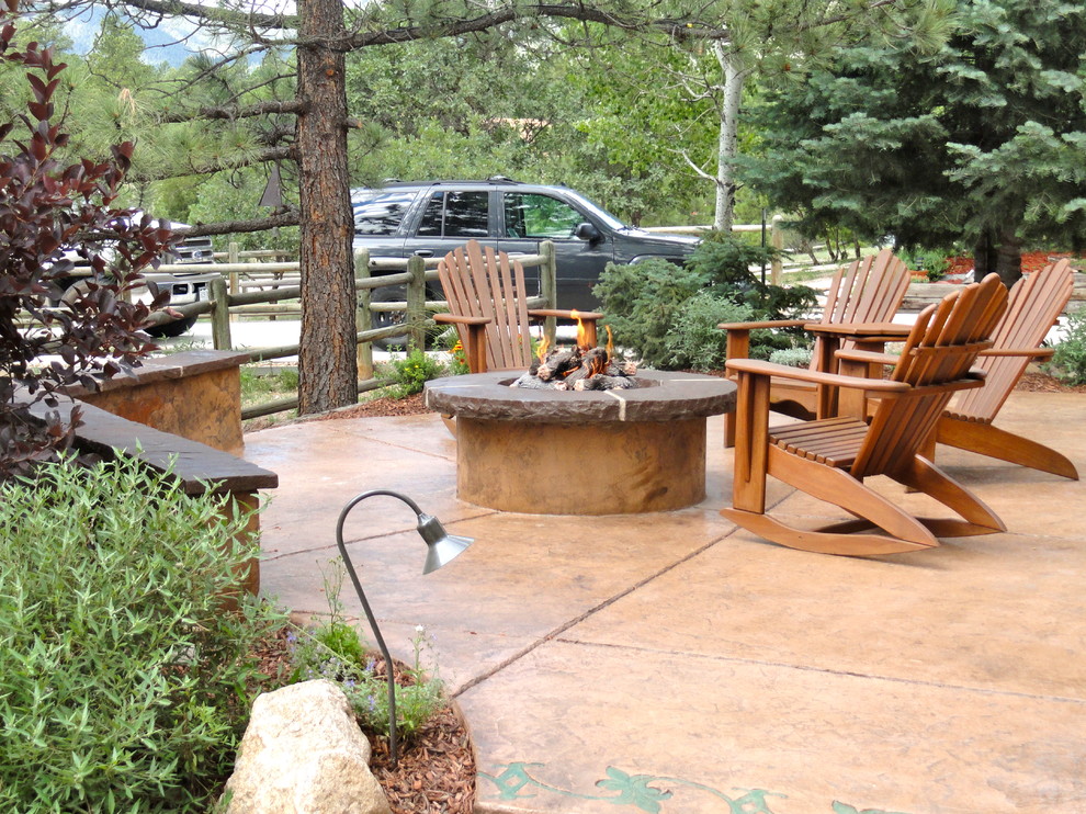 Traditional side yard patio in Denver with stamped concrete.