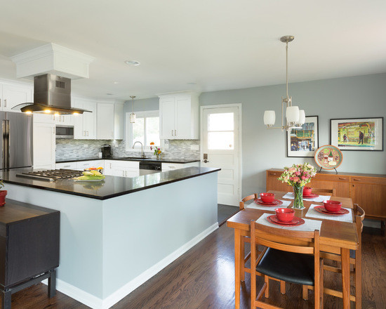 Inspiration for a large transitional l-shaped medium tone wood floor open concept kitchen remodel in Chicago with an undermount sink, shaker cabinets, white cabinets, granite countertops, multicolored backsplash, ceramic backsplash, stainless steel appliances and no island