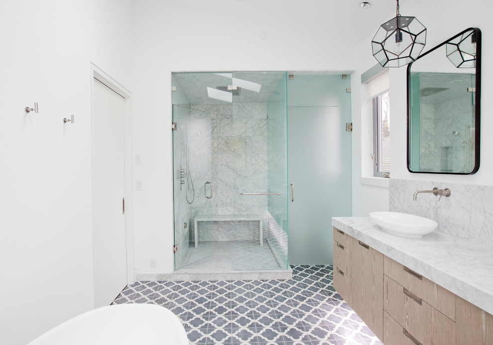 Photo of a large contemporary kids bathroom in Vancouver with an undermount sink, flat-panel cabinets, medium wood cabinets, a freestanding tub, a corner shower, a one-piece toilet, gray tile, stone tile, white walls, concrete floors and marble benchtops.