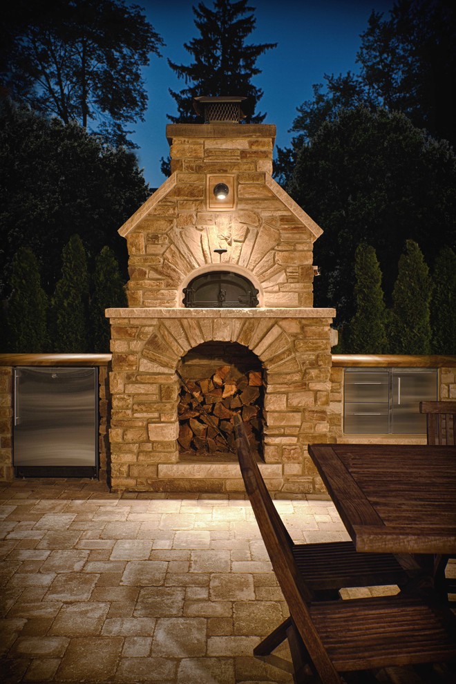 Design ideas for a large country backyard patio in Detroit with an outdoor kitchen, brick pavers and no cover.
