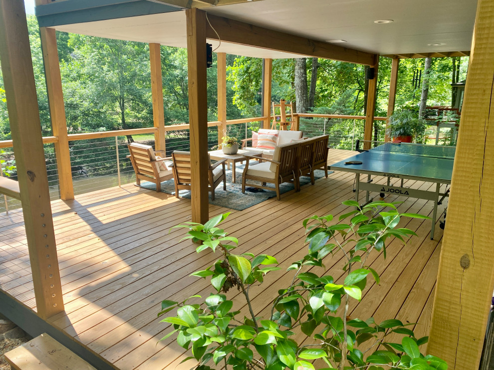 Expansive contemporary back first floor wire cable railing terrace in Atlanta with a roof extension.