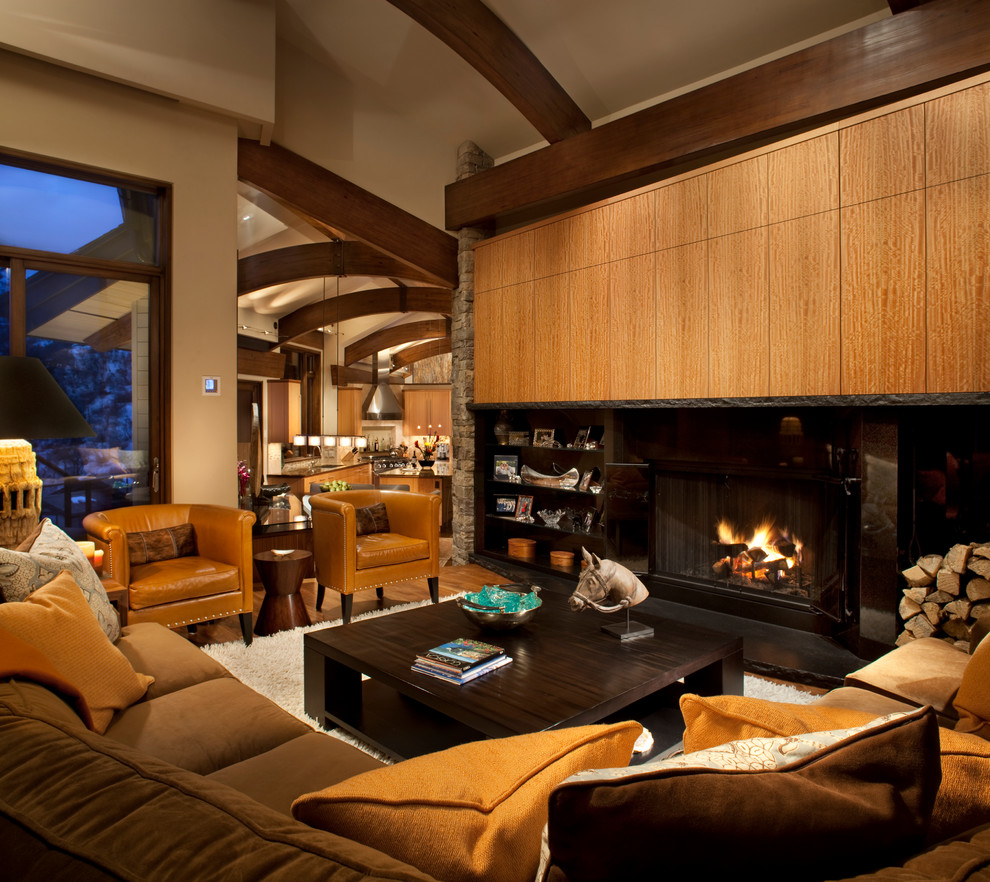 This is an example of a mid-sized contemporary formal open concept living room in Denver with beige walls, a standard fireplace, medium hardwood floors, a metal fireplace surround and no tv.
