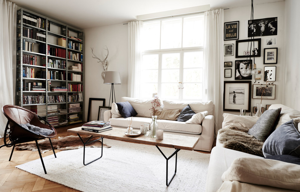 Inspiration for a small scandinavian formal enclosed living room in Munich with white walls, light hardwood floors, beige floor and no fireplace.