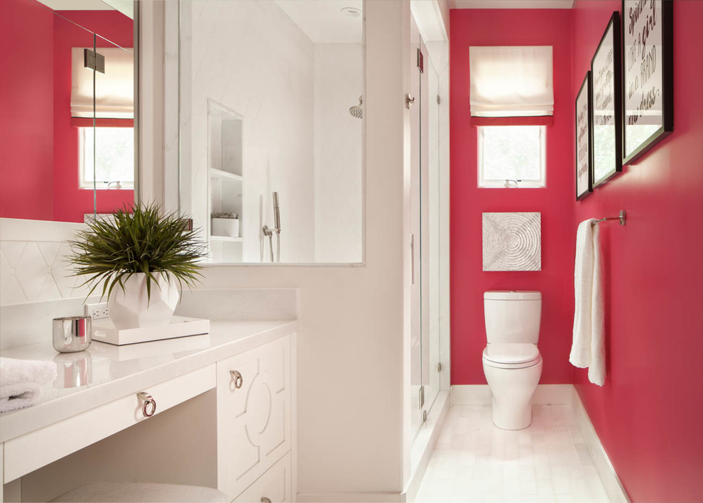 Inspiration for a transitional 3/4 bathroom in San Francisco with raised-panel cabinets, white cabinets, a corner shower, a two-piece toilet, pink walls and a hinged shower door.