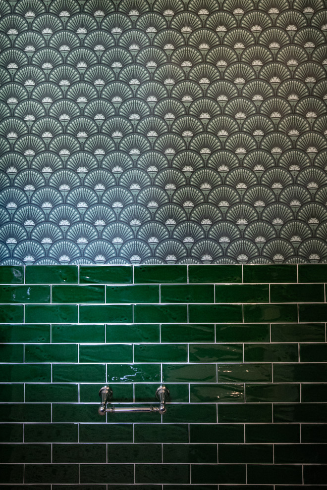 Example of a mid-sized transitional green tile and ceramic tile mosaic tile floor, multicolored floor and wallpaper powder room design with a one-piece toilet, green walls, an undermount sink, solid surface countertops and white countertops
