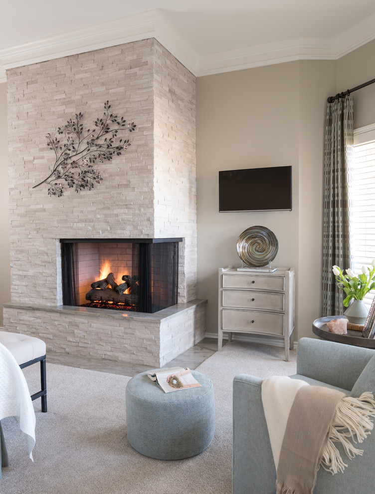 Inspiration for a mid-sized transitional master bedroom in Dallas with beige walls, carpet, a corner fireplace, a stone fireplace surround and beige floor.