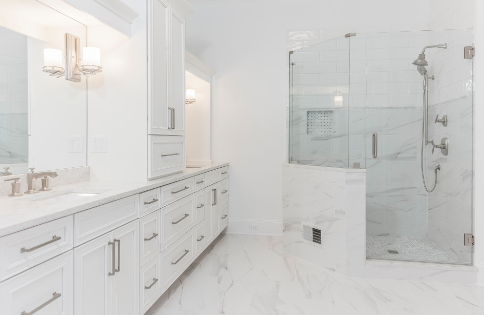 Design ideas for an expansive contemporary master bathroom in Atlanta with recessed-panel cabinets, white cabinets, a freestanding tub, a two-piece toilet, white tile, marble, white walls, porcelain floors, an undermount sink, engineered quartz benchtops and white floor.