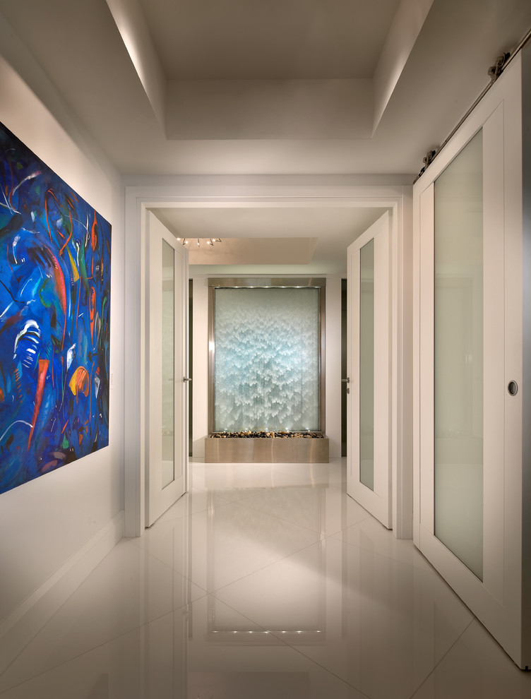 Design ideas for a contemporary hallway in Miami with white walls and white floor.