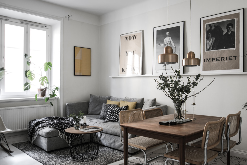 Design ideas for a scandinavian open concept living room in Stockholm with grey walls and grey floor.