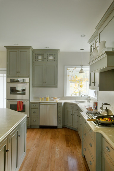 Inspiration for a large traditional l-shaped eat-in kitchen in Boston with an undermount sink, beaded inset cabinets, grey cabinets, limestone benchtops, stainless steel appliances, medium hardwood floors and with island.