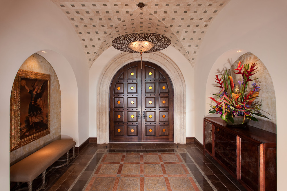 Inspiration for a mediterranean entryway in Austin with a double front door and a dark wood front door.