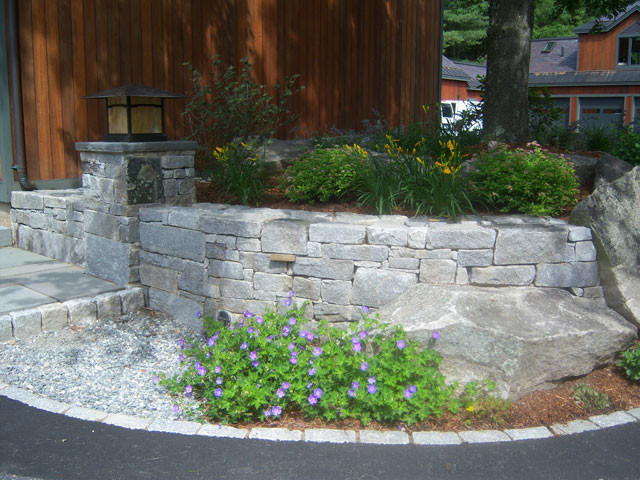 Inspiration for a mid-sized partial sun front yard stone landscaping in Boston.