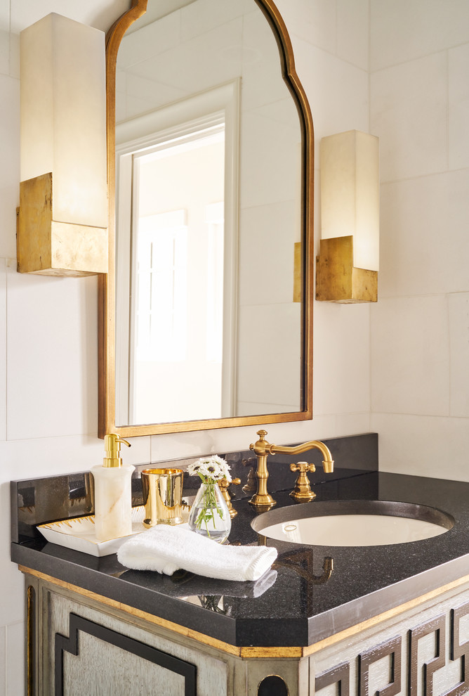 Photo of a mid-sized transitional bathroom in Other with furniture-like cabinets, a corner shower, a one-piece toilet, white tile, marble, grey walls, marble floors, an undermount sink, granite benchtops, white floor and a hinged shower door.
