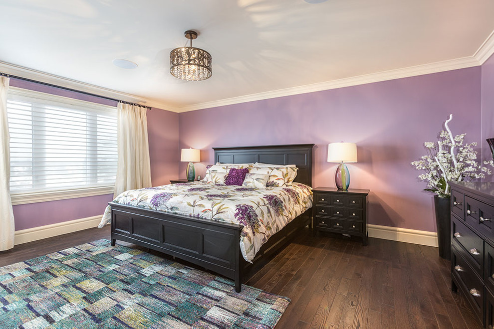 This is an example of a mid-sized traditional master bedroom in Other with purple walls, dark hardwood floors, no fireplace and brown floor.