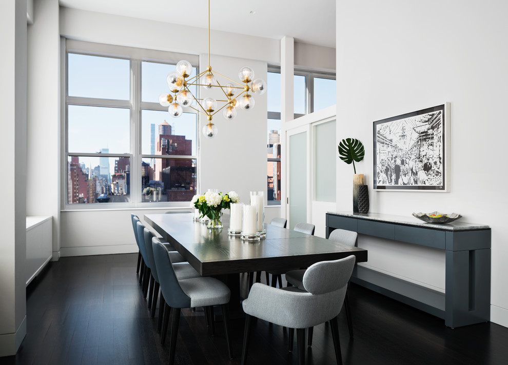 Inspiration for a contemporary dining room in New York with white walls and dark hardwood floors.