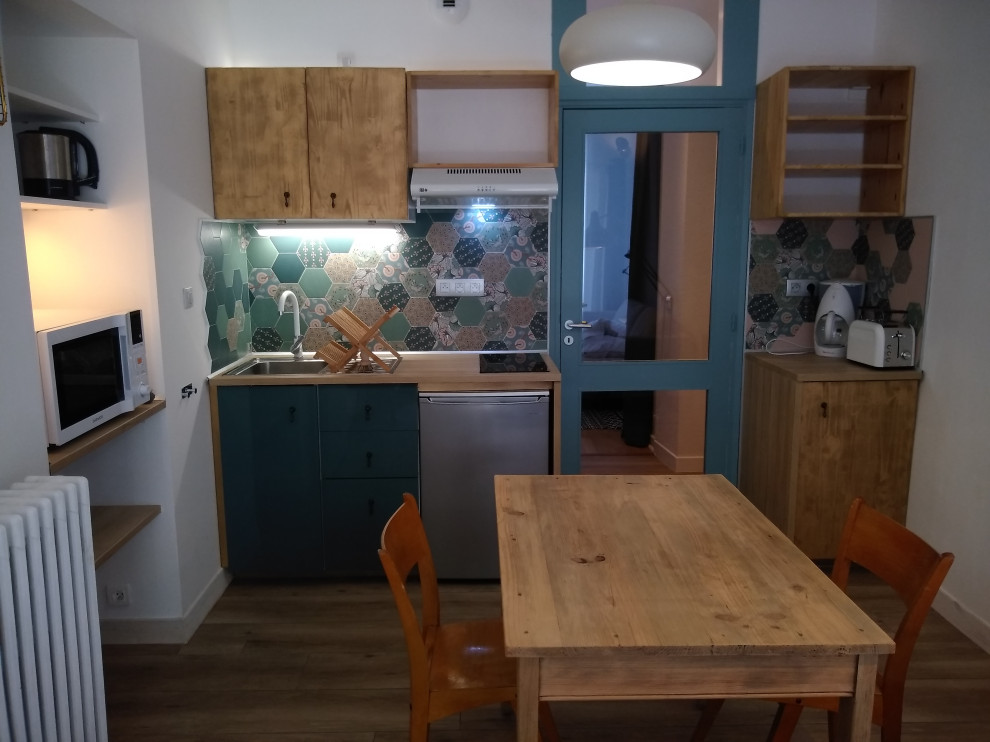 Inspiration for a small eclectic single-wall open plan kitchen in Other with turquoise cabinets, ceramic flooring and no island.