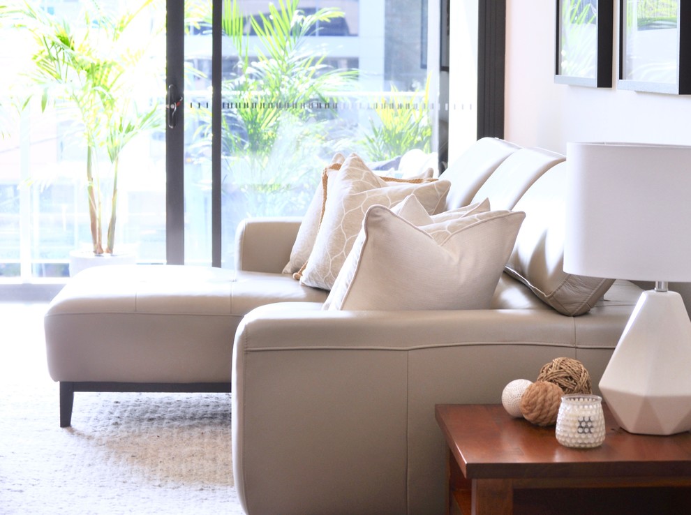Inspiration for a small transitional open concept living room in Sydney with beige walls and a freestanding tv.