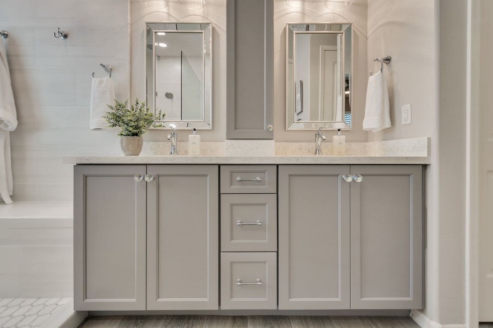 Mid-sized transitional master white tile and porcelain tile wood-look tile floor, multicolored floor and double-sink doorless shower photo in Phoenix with shaker cabinets, gray cabinets, gray walls, an undermount sink, granite countertops, white countertops and a niche