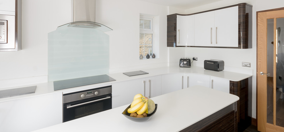 Photo of a large modern kitchen with white cabinets and an island.