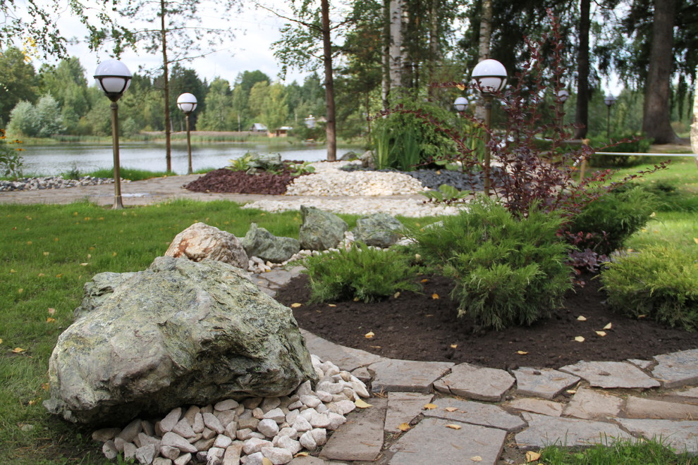 Цветник с камнями и композицией из кустарника