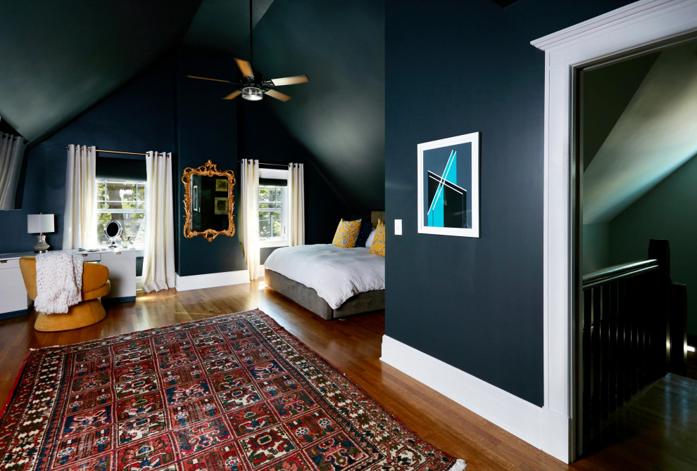 This is an example of a large traditional master bedroom in New York with blue walls, medium hardwood flooring, brown floors and a vaulted ceiling.