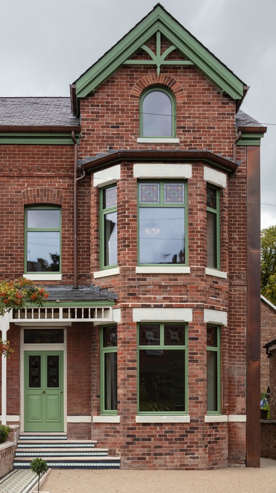 Inspiration for a traditional two-storey brick red house exterior in Manchester with a gable roof and a shingle roof.