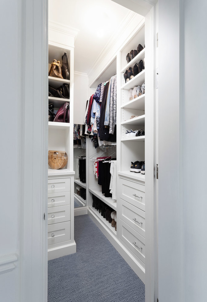 Photo of a small traditional women's walk-in wardrobe in Detroit with recessed-panel cabinets, white cabinets, carpet and blue floor.