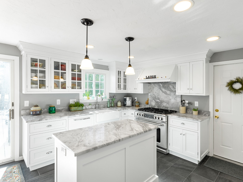 Design ideas for a mid-sized traditional l-shaped eat-in kitchen in Boston with a farmhouse sink, shaker cabinets, white cabinets, marble benchtops, multi-coloured splashback, stone slab splashback, panelled appliances, porcelain floors, with island and grey floor.