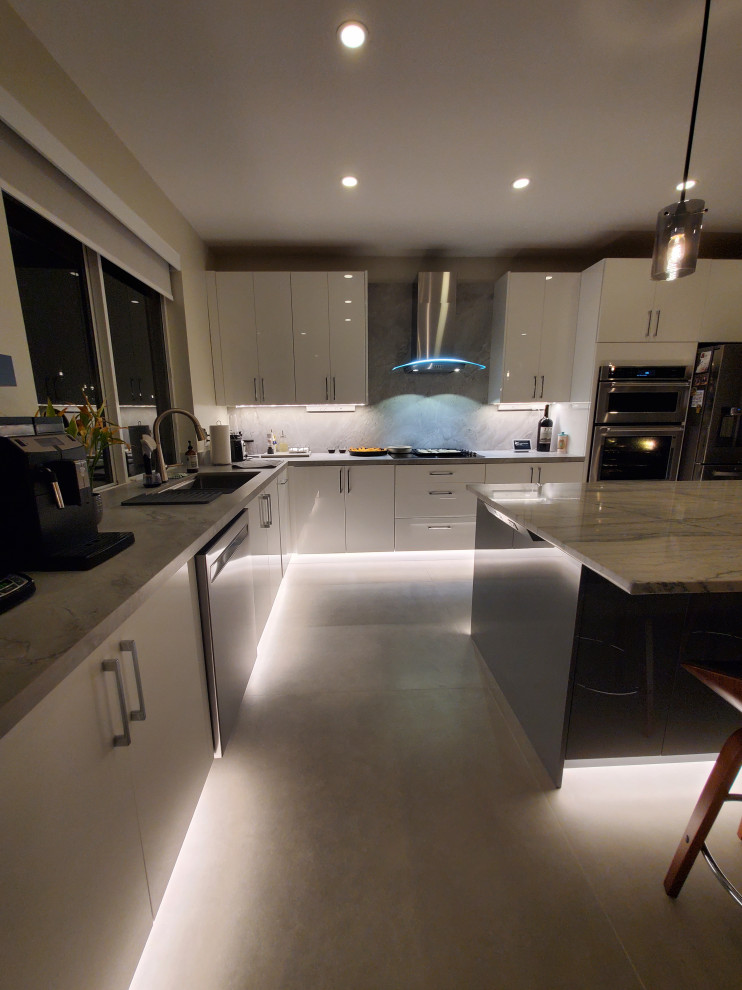 Large modern l-shaped kitchen/diner in Miami with flat-panel cabinets, white cabinets and an island.