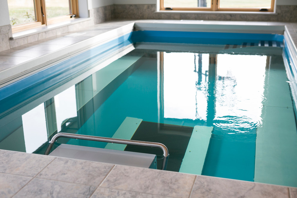 Inspiration for a mid-sized transitional indoor rectangular lap pool in Other with a pool house and tile.