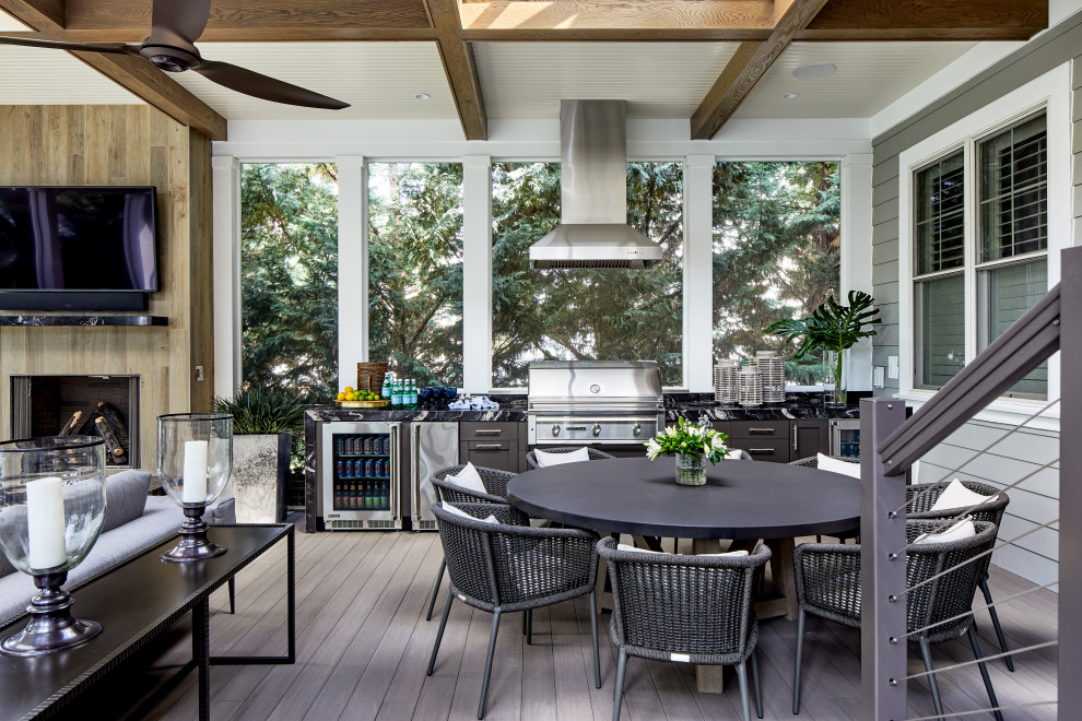 Inspiration for an expansive transitional backyard verandah in DC Metro with an outdoor kitchen and cable railing.