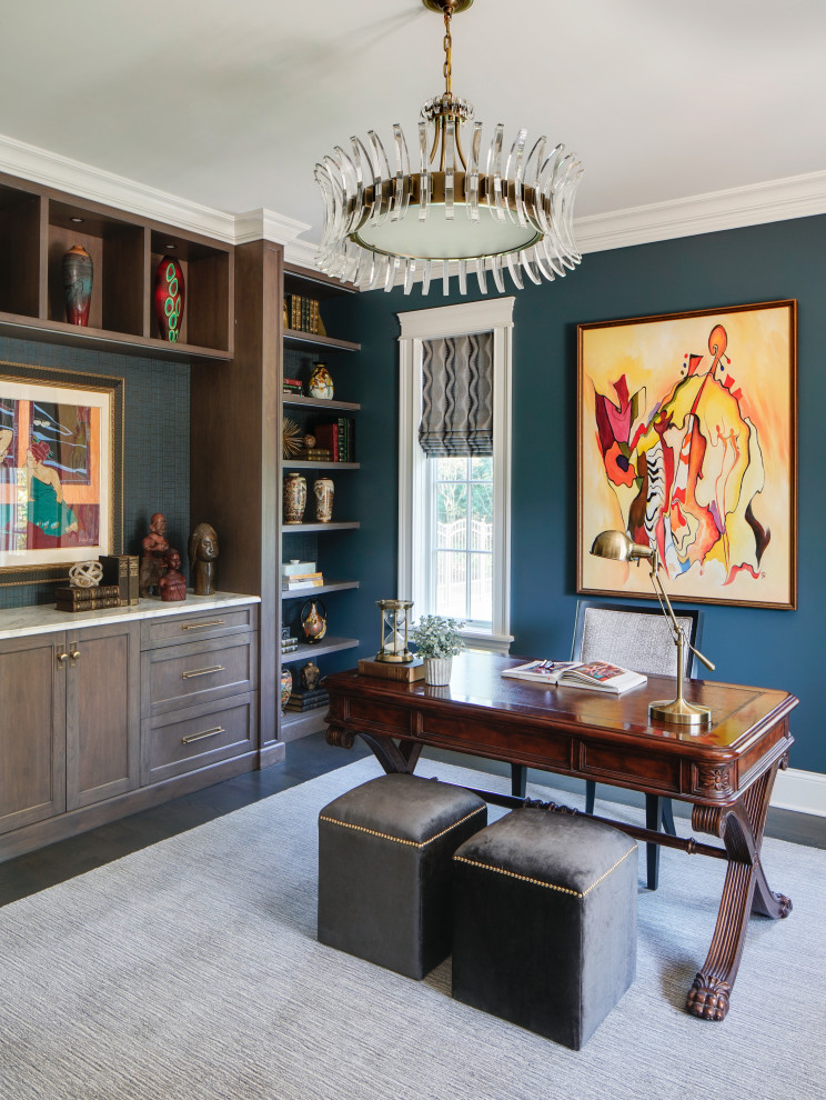 Inspiration for a large traditional study room in Chicago with blue walls, dark hardwood floors, no fireplace, a freestanding desk and brown floor.