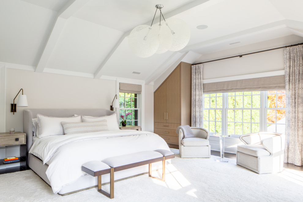 Design ideas for an expansive traditional master bedroom in New York with beige walls, dark hardwood flooring and exposed beams.