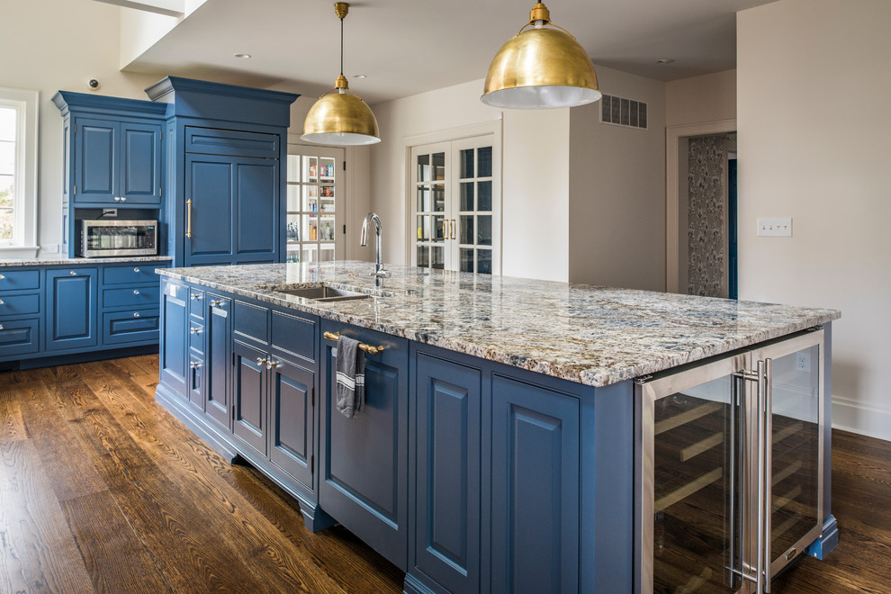 Example of a mid-sized trendy l-shaped medium tone wood floor and brown floor open concept kitchen design in Cincinnati with a double-bowl sink, raised-panel cabinets, blue cabinets, granite countertops, paneled appliances, an island and gray countertops
