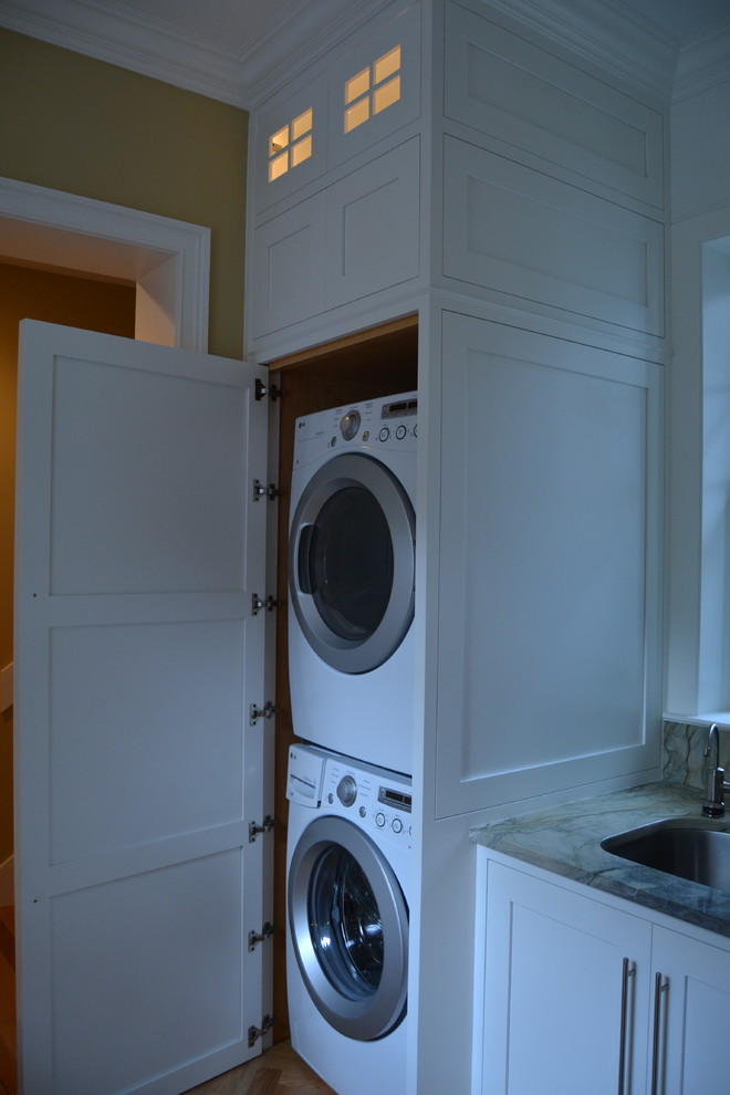 Photo of a large modern laundry room in Jacksonville with beaded inset cabinets and white cabinets.