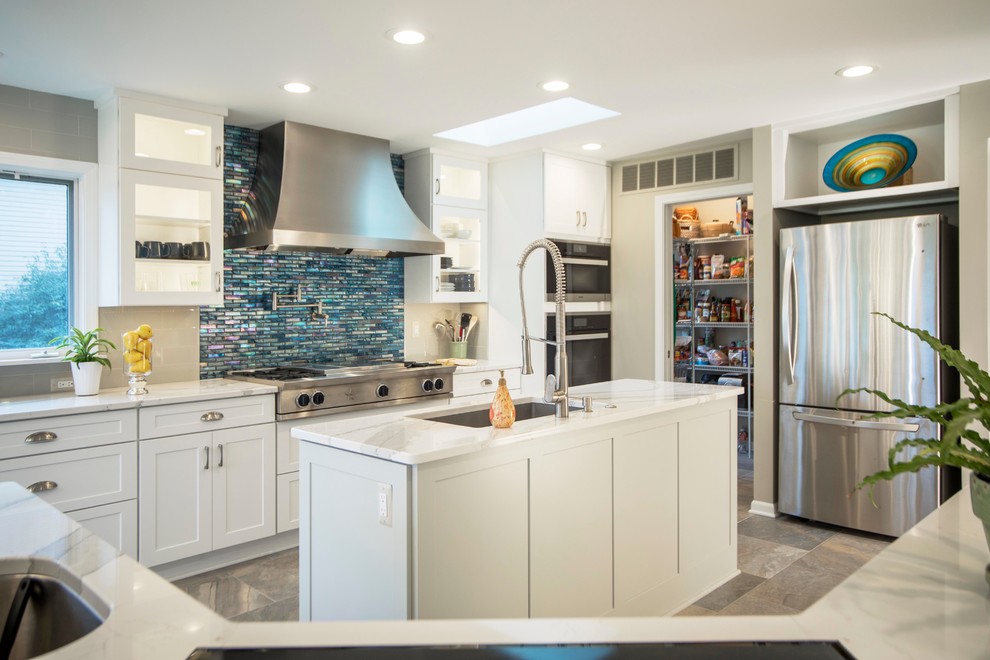 Contemporary kitchen in Detroit with a drop-in sink, white cabinets, quartzite benchtops, blue splashback, glass tile splashback, stainless steel appliances, porcelain floors and with island.