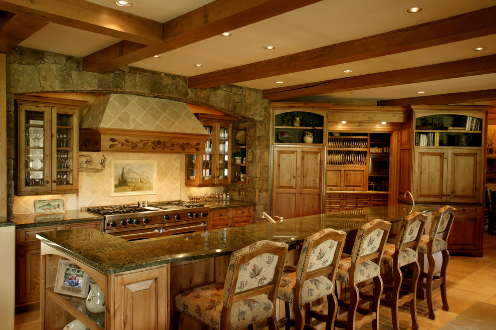 This is an example of a country kitchen in Denver with glass-front cabinets, medium wood cabinets and panelled appliances.