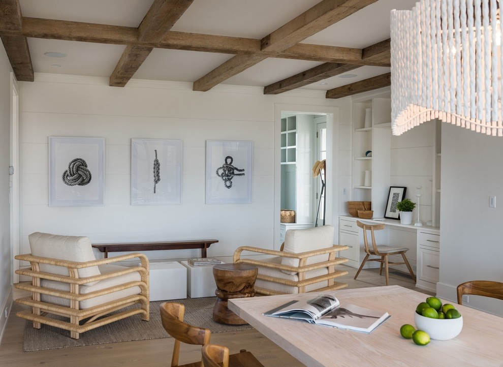 Inspiration for a mid-sized beach style study room in Providence with white walls, light hardwood floors, no fireplace, a built-in desk and beige floor.