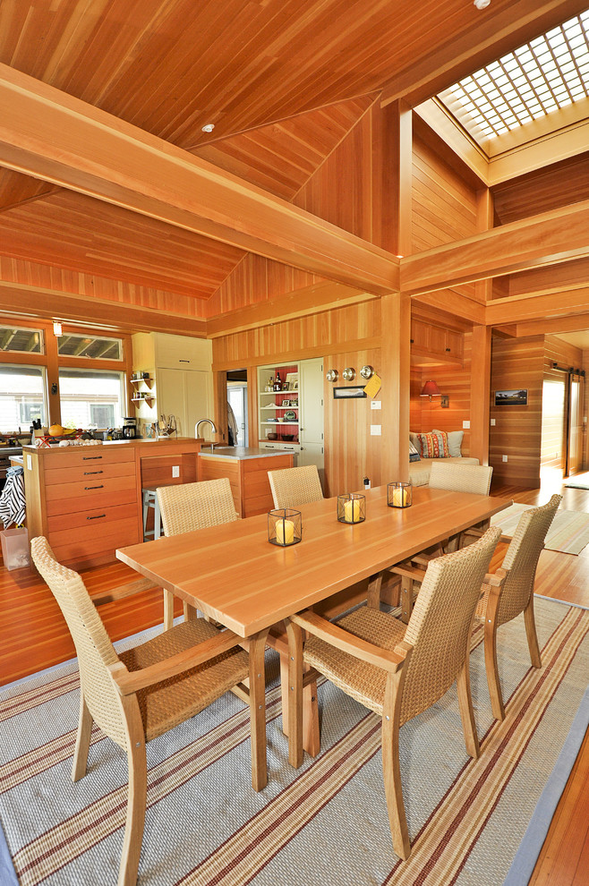 This is an example of a beach style dining room in Boston with medium hardwood floors.