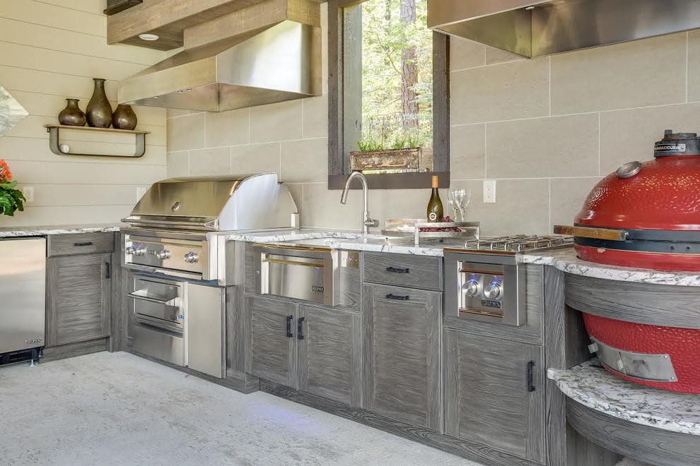 Inspiration for an expansive contemporary l-shaped kitchen in Birmingham with a farmhouse sink, louvered cabinets, distressed cabinets, granite benchtops, stainless steel appliances and concrete floors.