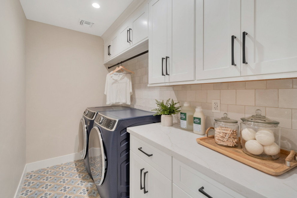 Kitchen pantry - large transitional l-shaped porcelain tile and beige floor kitchen pantry idea in Phoenix with a farmhouse sink, shaker cabinets, white cabinets, quartz countertops, white backsplash, ceramic backsplash, stainless steel appliances, an island and white countertops