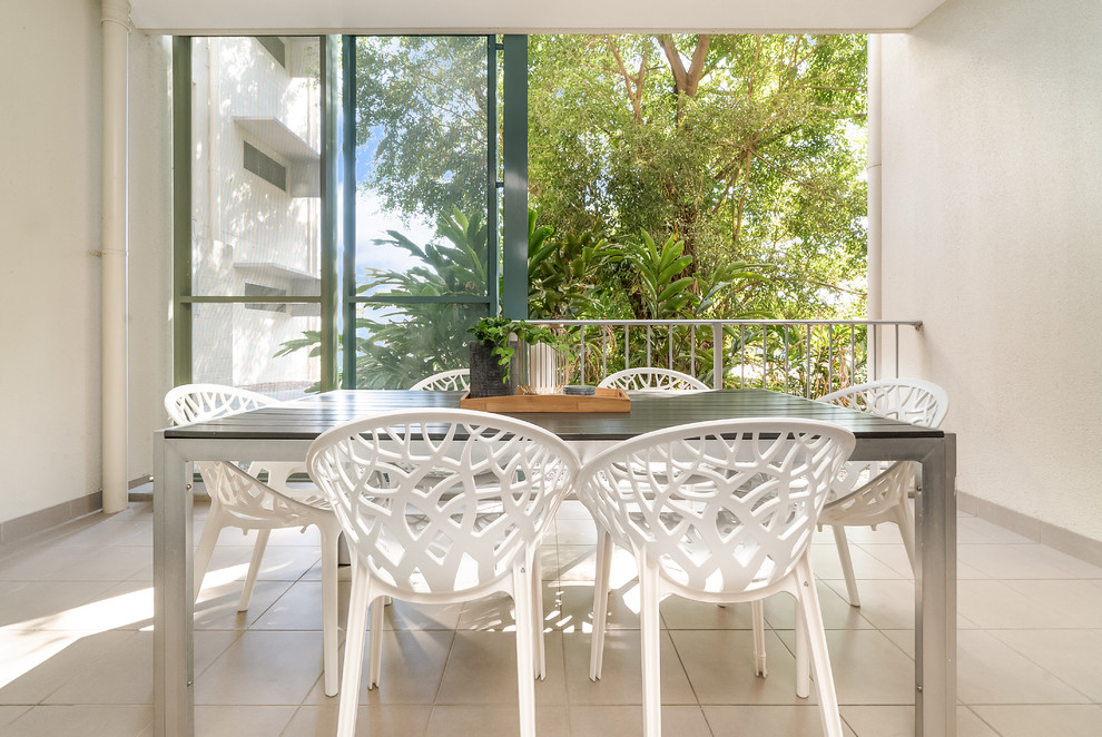 This is an example of a contemporary balcony in Darwin with a roof extension and metal railing.
