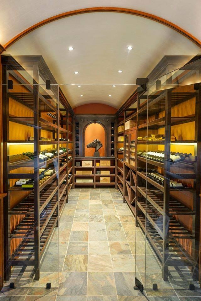 Photo of a large traditional wine cellar in Philadelphia with limestone floors and beige floor.