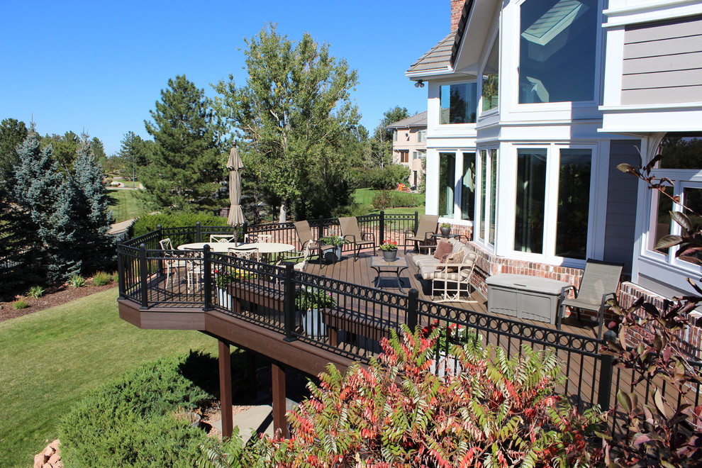 Example of a large transitional backyard outdoor kitchen deck design in Denver with no cover