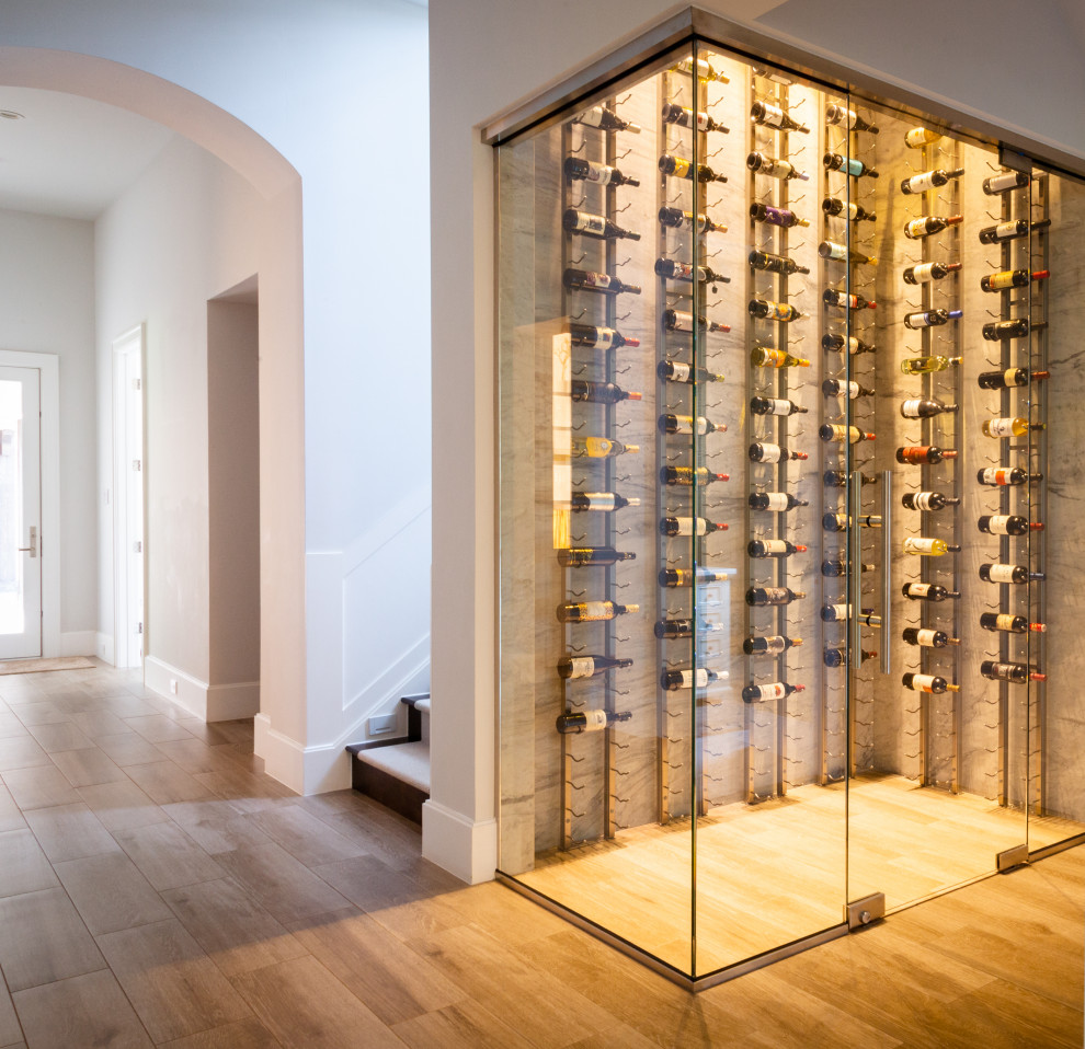 Medium sized traditional wine cellar in Houston with porcelain flooring and display racks.