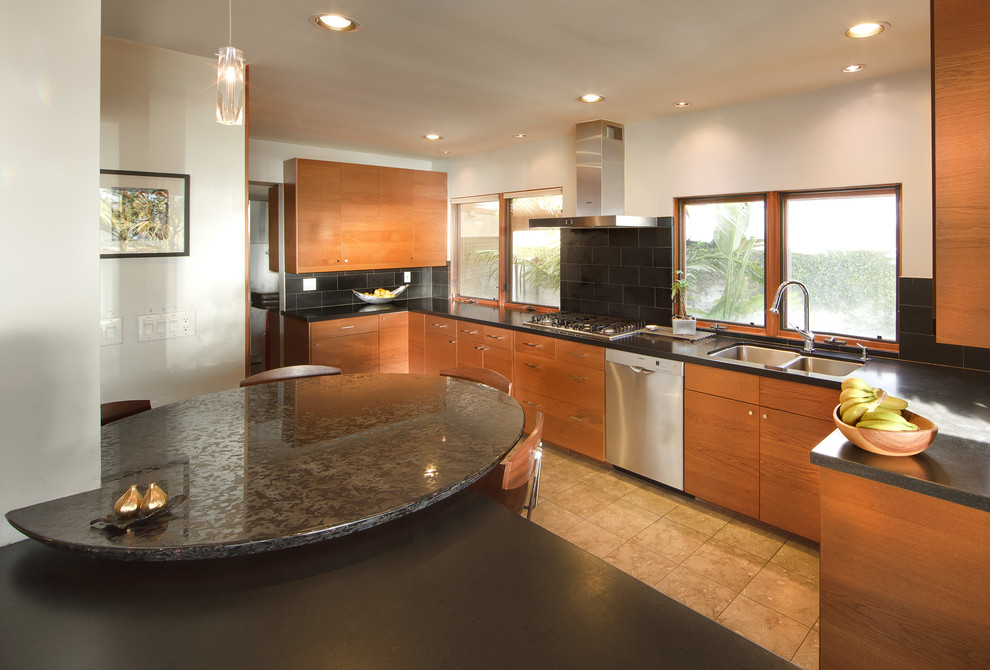 Photo of a mid-sized contemporary galley open plan kitchen in Los Angeles with an undermount sink, flat-panel cabinets, light wood cabinets, quartz benchtops, black splashback, porcelain splashback, stainless steel appliances, porcelain floors, no island, beige floor and black benchtop.