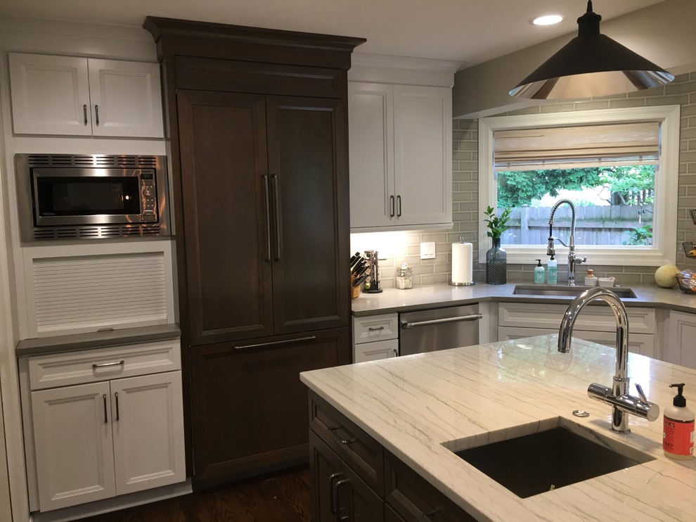 Large transitional u-shaped dark wood floor and brown floor open concept kitchen photo in Chicago with an undermount sink, flat-panel cabinets, white cabinets, quartz countertops, gray backsplash, ceramic backsplash, stainless steel appliances, an island and gray countertops