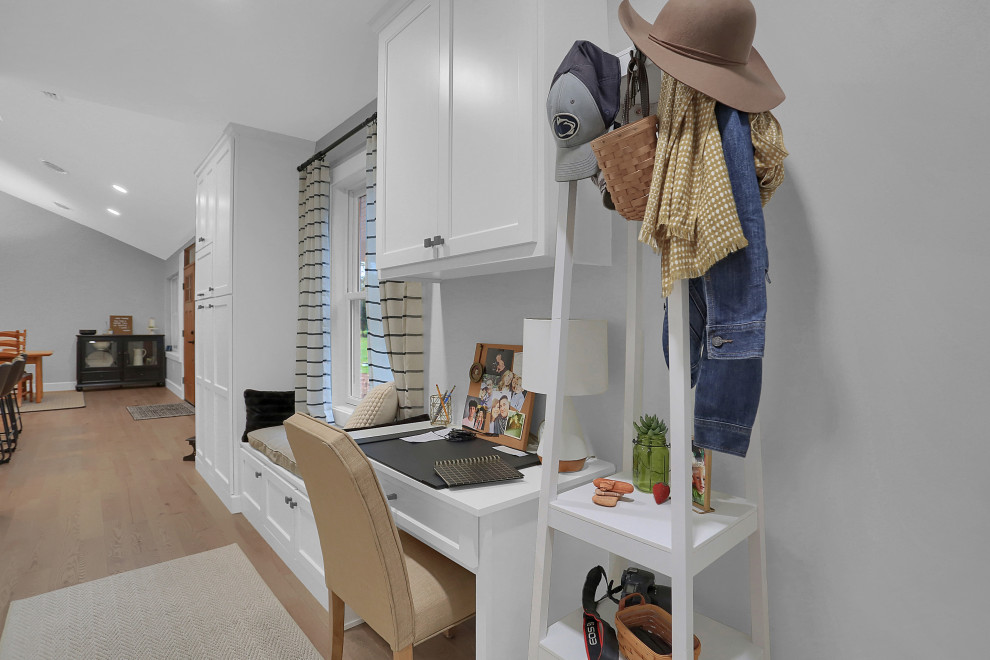 Mid-sized transitional l-shaped open concept kitchen photo with flat-panel cabinets, white cabinets, quartz countertops, gray backsplash, an island and white countertops
