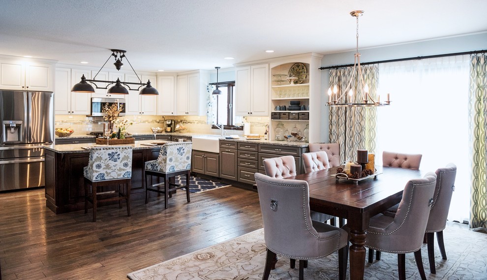 Mid-sized transitional single-wall dark wood floor kitchen photo with a farmhouse sink, raised-panel cabinets, distressed cabinets, quartz countertops, gray backsplash, ceramic backsplash, stainless steel appliances and an island