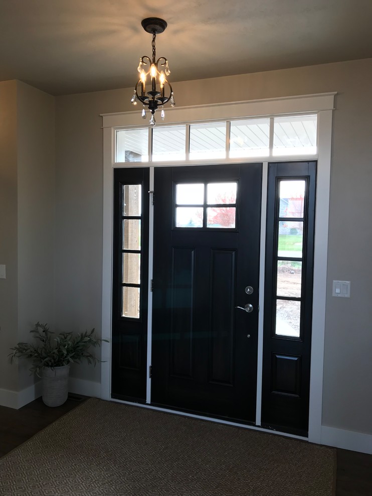 Mid-sized contemporary front door in Other with beige walls, vinyl floors, a single front door, a black front door and brown floor.
